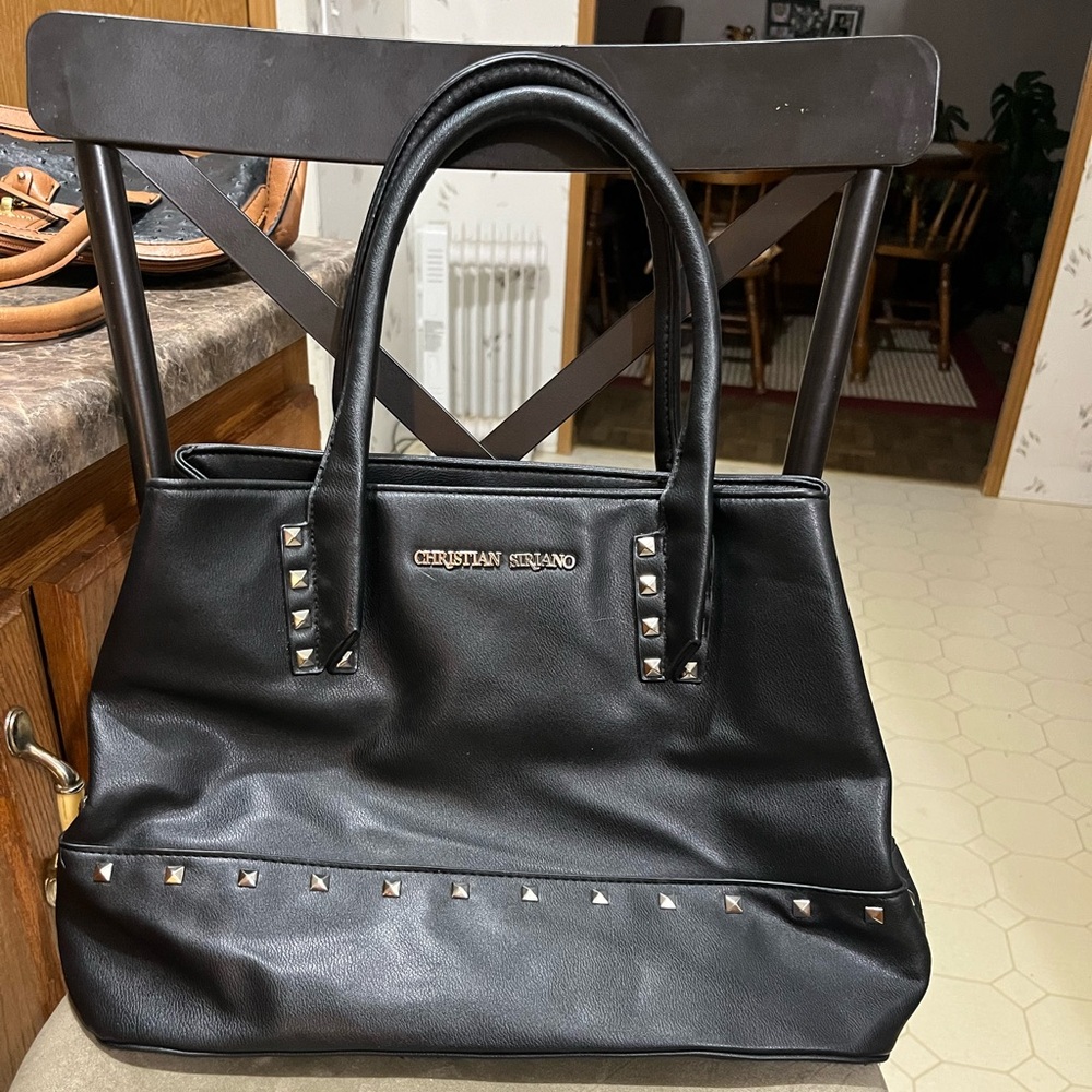 Beautiful black with pinstripe liner Christian Soriano bag.